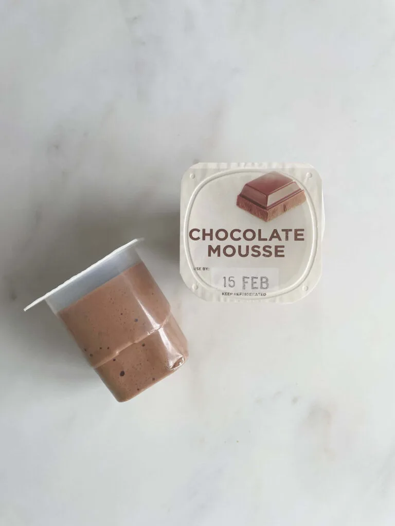 Two containers of chocolate mousse