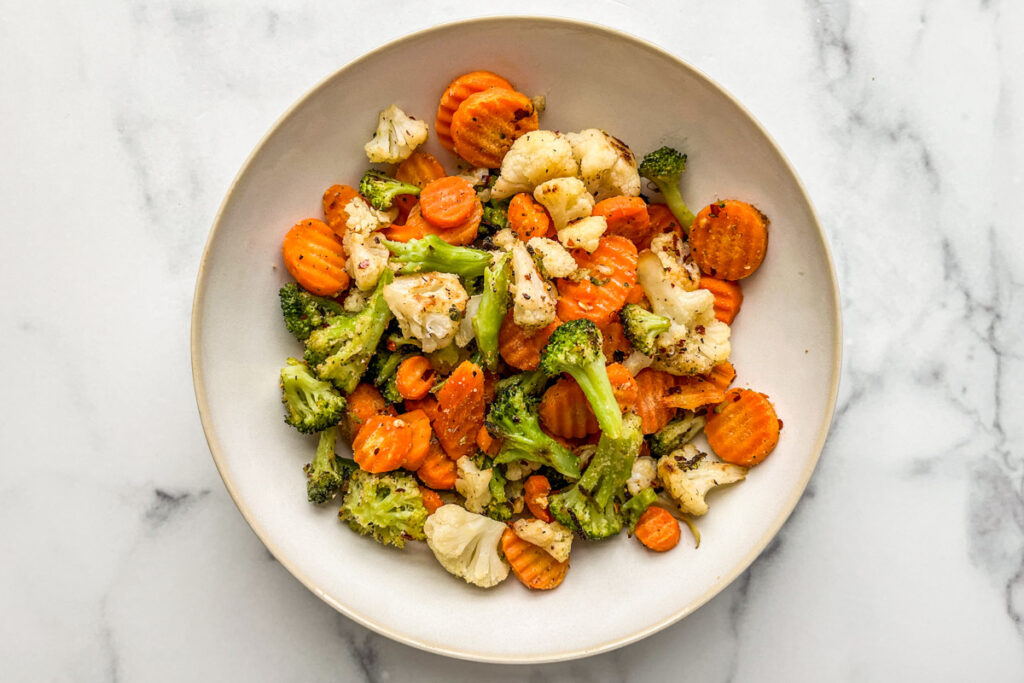 A serving bowl with roasted California blend veggies.