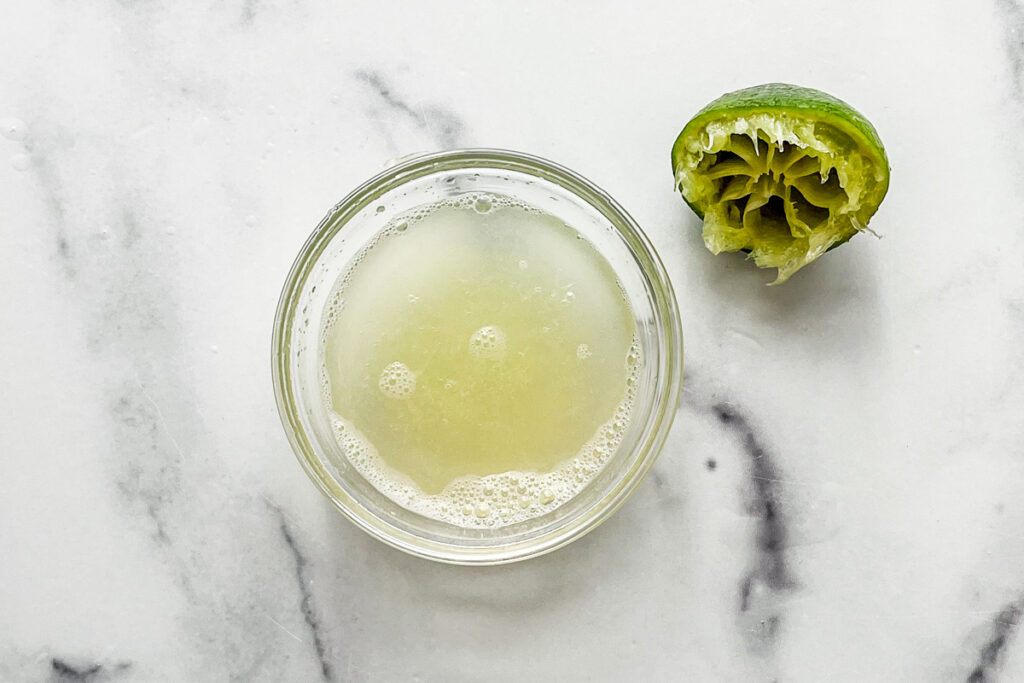 Freshly squeezed lime juice in a glass bowl.