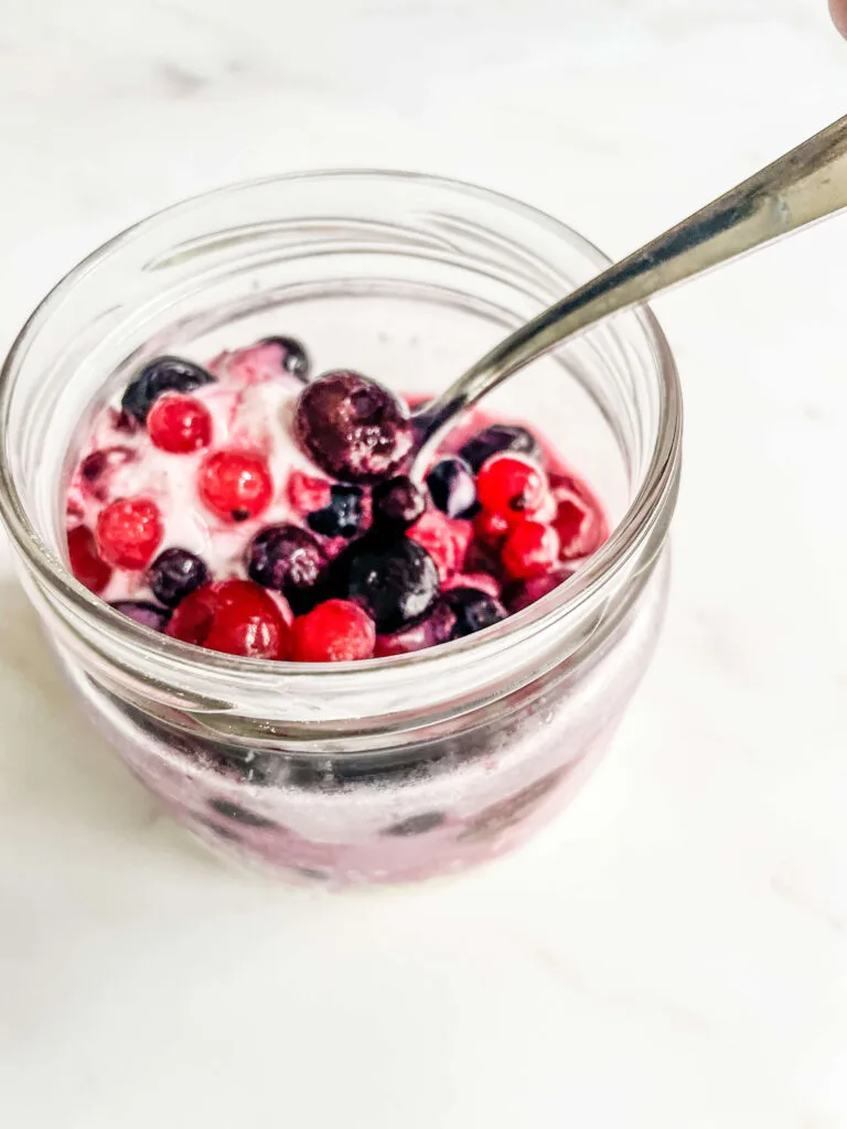 Overnight Oats with Frozen Berries in Jar with Spoon