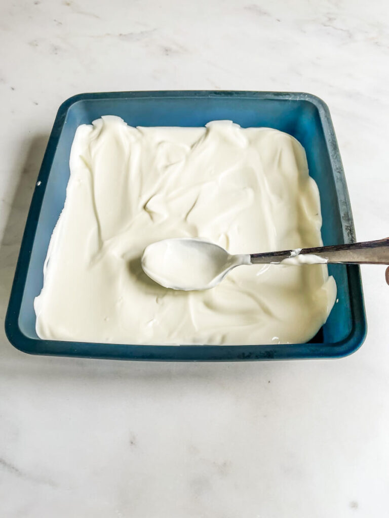 Yogurt in a baking sheet with spoon